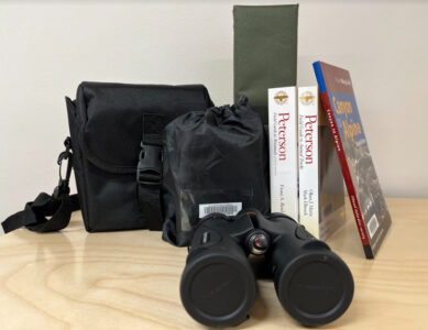 Kit with binoculars, sitting pads, and animal identification books.